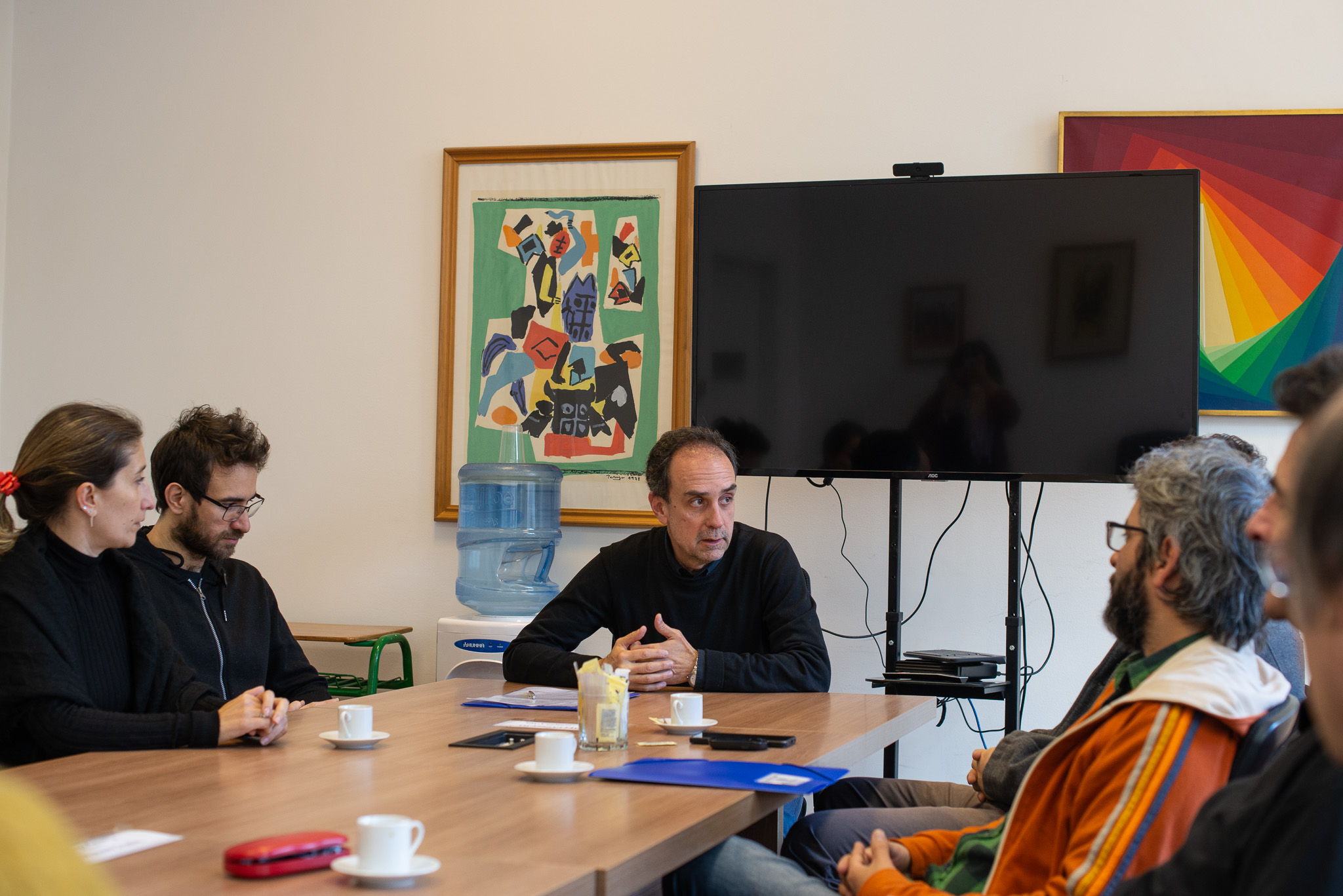 Se ve la mesa del Consejo de Facultad de Artes, de izquierda a derecha se encuentran sentados Parentelli, Varela, Miranda, Pereira.