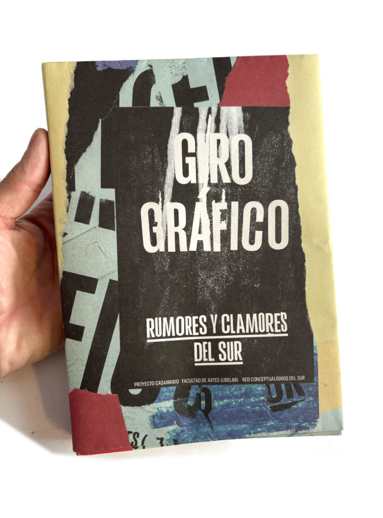 Mano sosteniendo el libro "Giro Gráfico"