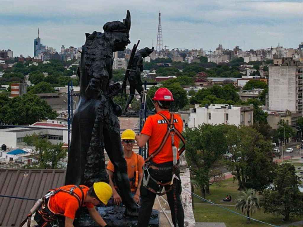 Fotografía tomada desde el techo del Palacio Legislativo en la que se ven operarios trabajando/colocando una escultura